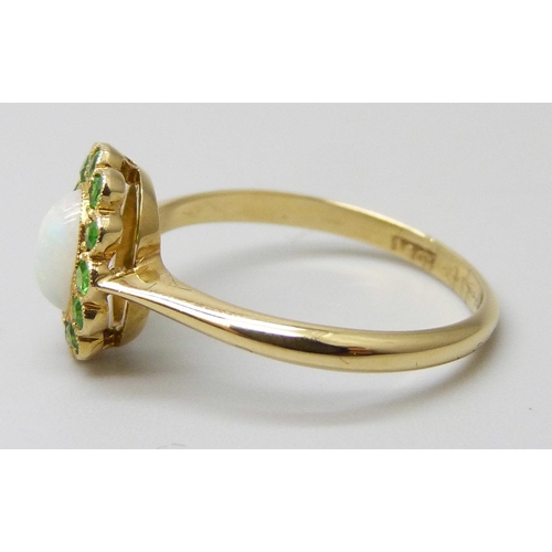 7016 - An early 20th Century 18ct yellow gold halo ring set with Demantoid garnets and an opal, 2.3g, M