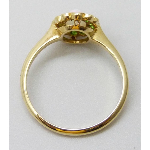 7016 - An early 20th Century 18ct yellow gold halo ring set with Demantoid garnets and an opal, 2.3g, M