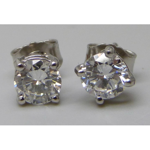 7019 - A pair of hallmarked platinum set diamond stud earrings, total diamond weight 1.32ct