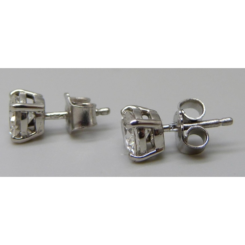 7019 - A pair of hallmarked platinum set diamond stud earrings, total diamond weight 1.32ct