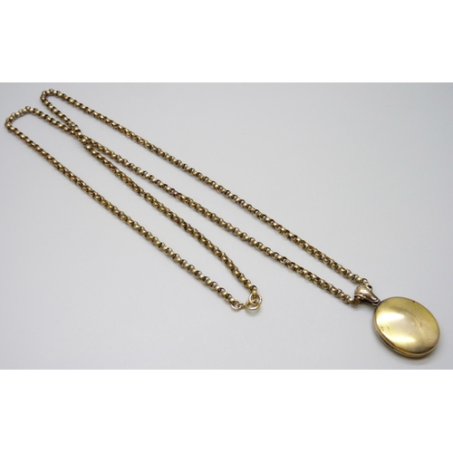 7022 - A gilt metal long guard chain and locket, 93cm