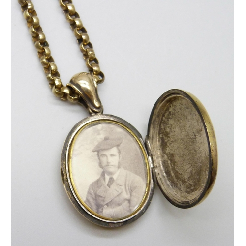 7022 - A gilt metal long guard chain and locket, 93cm