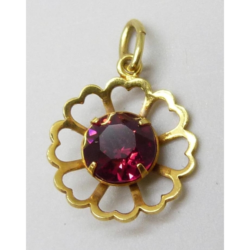 7023 - A 9ct gold pendant set with a red paste stone, 0.8g, 1.8cm