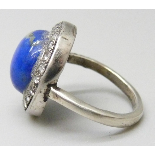 7025 - An Art Deco lapis lazuli and diamond ring, stamped 750, 5.6g, J