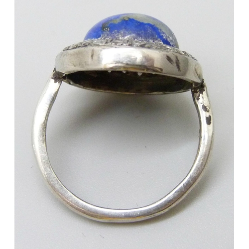 7025 - An Art Deco lapis lazuli and diamond ring, stamped 750, 5.6g, J