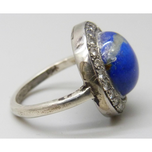 7025 - An Art Deco lapis lazuli and diamond ring, stamped 750, 5.6g, J