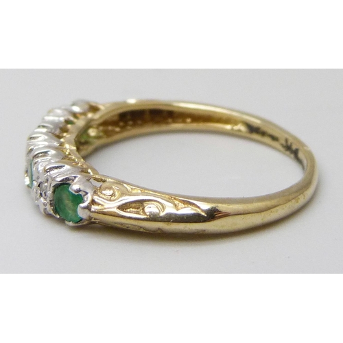 7030 - A yellow metal, emerald and diamond ring, stamped 9k, 1.8g, N