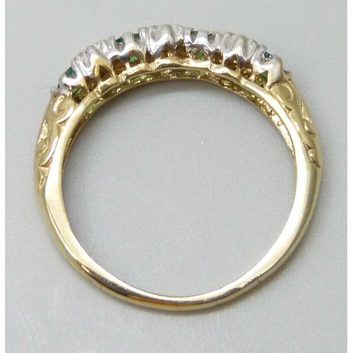 7030 - A yellow metal, emerald and diamond ring, stamped 9k, 1.8g, N