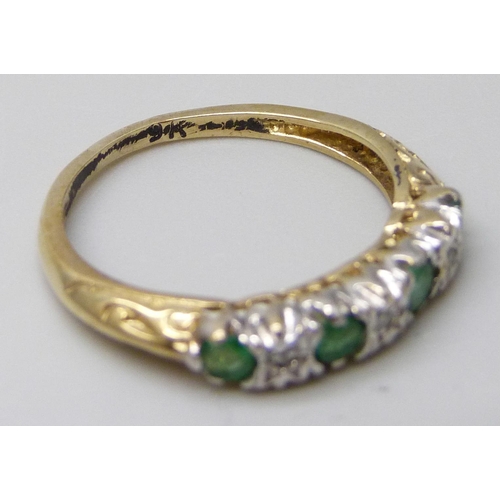 7030 - A yellow metal, emerald and diamond ring, stamped 9k, 1.8g, N