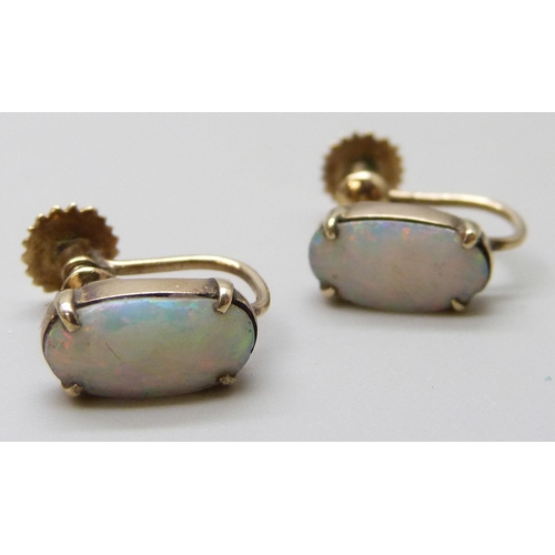 7033 - A pair of 9ct gold opal set earrings with screw backs, 2.1g