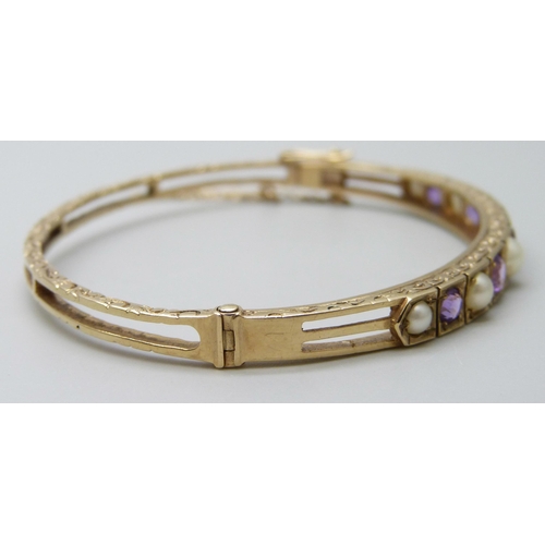 7038 - A 9ct gold, amethyst and pearl bangle, 11.8g, 5.9 x 5.1cm