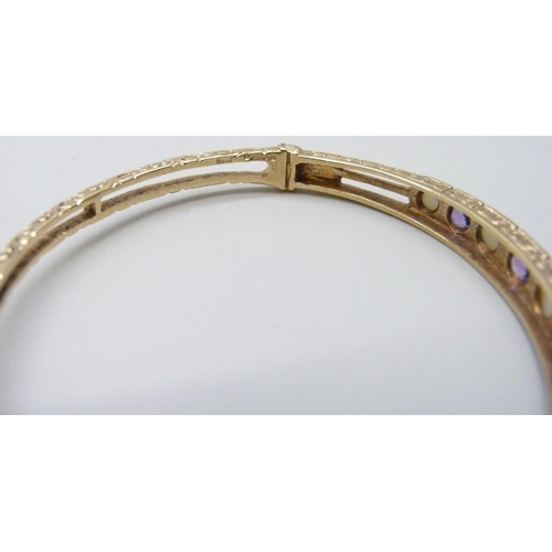 7038 - A 9ct gold, amethyst and pearl bangle, 11.8g, 5.9 x 5.1cm