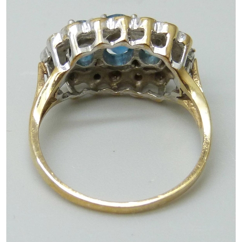 7045 - A 9ct gold, blue spinel and diamond accent ring, 3.1g, L