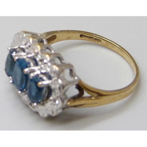 7045 - A 9ct gold, blue spinel and diamond accent ring, 3.1g, L