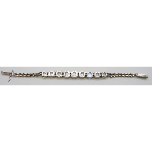 7048 - A silver bracelet set with moonstones and sapphires, 11g, 16cm