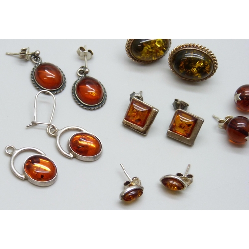 7056 - Five pairs of silver and amber earrings, one missing a hook, and a pair of amber stud earrings with ... 