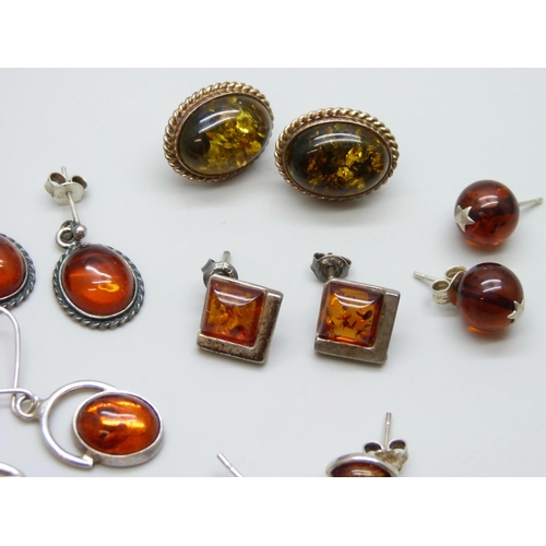 7056 - Five pairs of silver and amber earrings, one missing a hook, and a pair of amber stud earrings with ... 