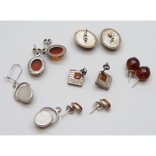 7056 - Five pairs of silver and amber earrings, one missing a hook, and a pair of amber stud earrings with ... 