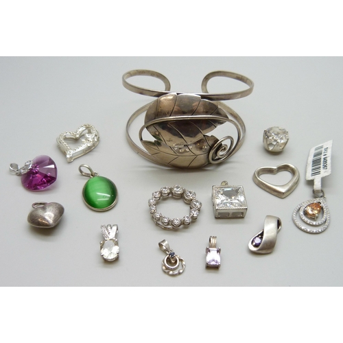 7063 - A silver bangle and a collection of silver pendants, 51g, together with two white metal pendants