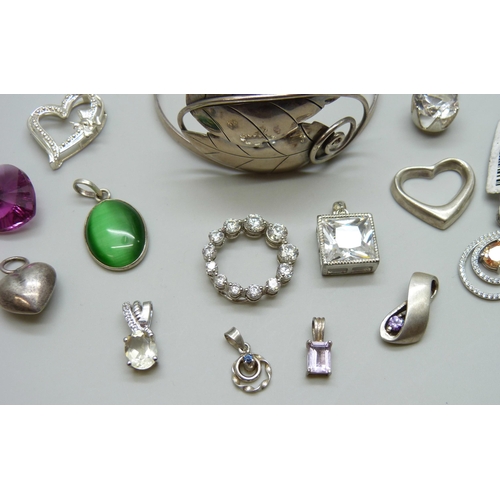 7063 - A silver bangle and a collection of silver pendants, 51g, together with two white metal pendants