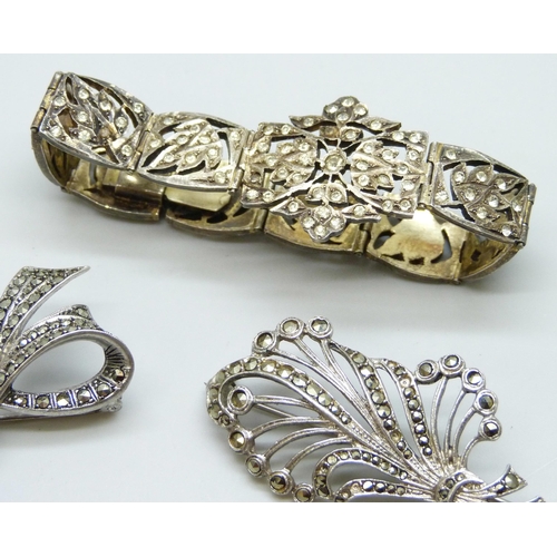 7078 - A gilt white metal bracelet set with paste stones, a silver bow brooch and a white metal brooch, 42g