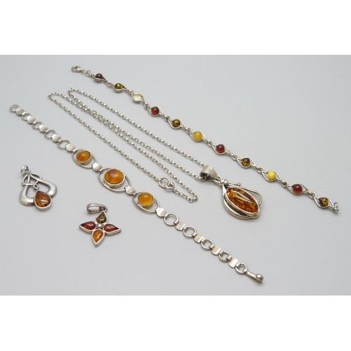 7080 - A collection of silver and amber jewellery - three pendants and a bracelet, together with another si... 