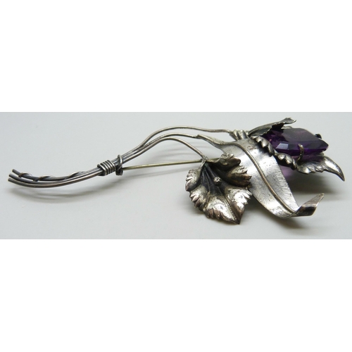 7093 - A large silver flower brooch marked sterling, set with a purple glass stone, 31g, 12.3g