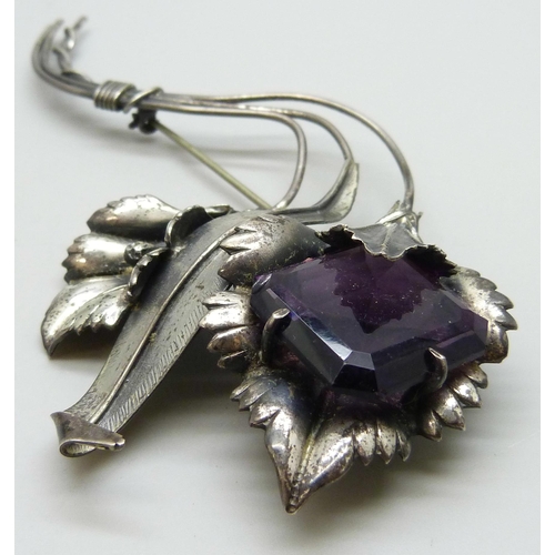 7093 - A large silver flower brooch marked sterling, set with a purple glass stone, 31g, 12.3g