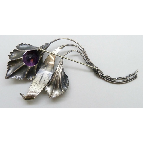 7093 - A large silver flower brooch marked sterling, set with a purple glass stone, 31g, 12.3g