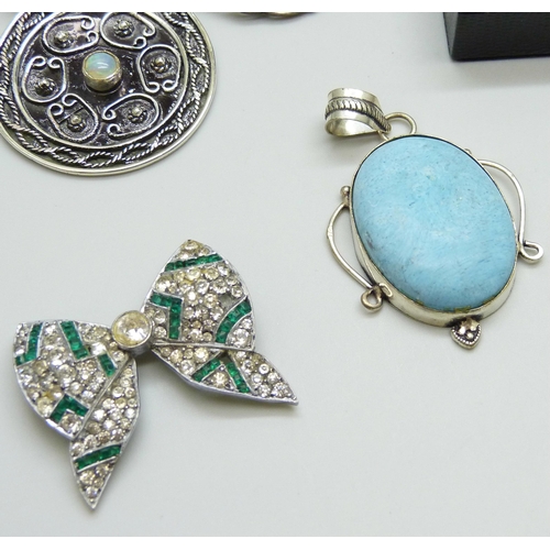 7098 - A collection of silver brooches and pendants, 57g, together with a silver plated pendant