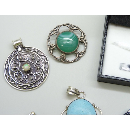 7098 - A collection of silver brooches and pendants, 57g, together with a silver plated pendant