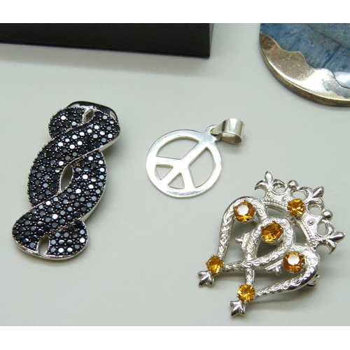 7098 - A collection of silver brooches and pendants, 57g, together with a silver plated pendant