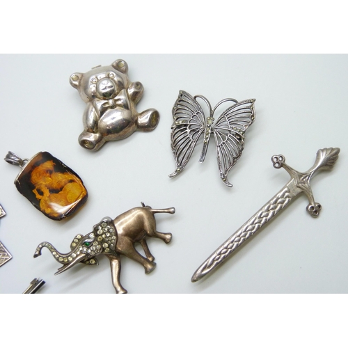 7109 - Ten silver pendants and brooches, 49g