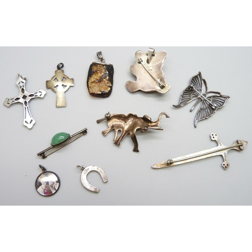 7109 - Ten silver pendants and brooches, 49g