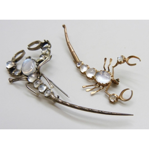 7115 - Two scorpion brooches set with moonstones, gilt example lacking hook, largest 7.2cm