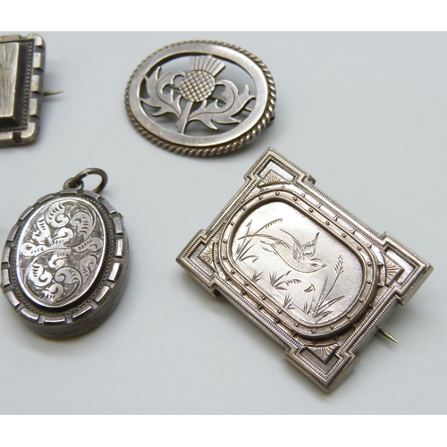 7117 - A Victorian silver locket, a Victorian silver brooch set with a stone, lacking pin, a silver thistle... 