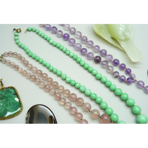 7118 - A carved green stone bird, a/f, 10.5cm, gemstone bead necklaces and brooches