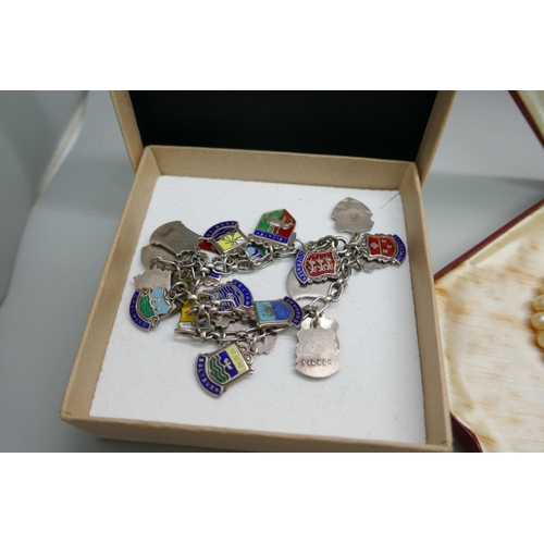 7158 - A collection of silver and costume jewellery including a white metal charm bracelet with enamelled c... 