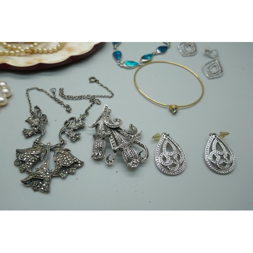 7158 - A collection of silver and costume jewellery including a white metal charm bracelet with enamelled c... 