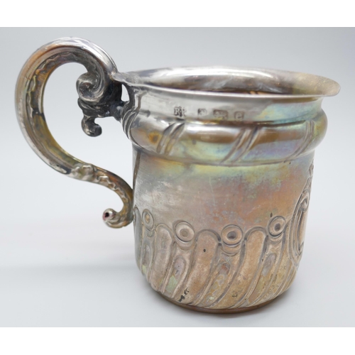 7232 - A small silver mug with embossed decoration, Birmingham 1904, a/f, 52g, 6.5cm