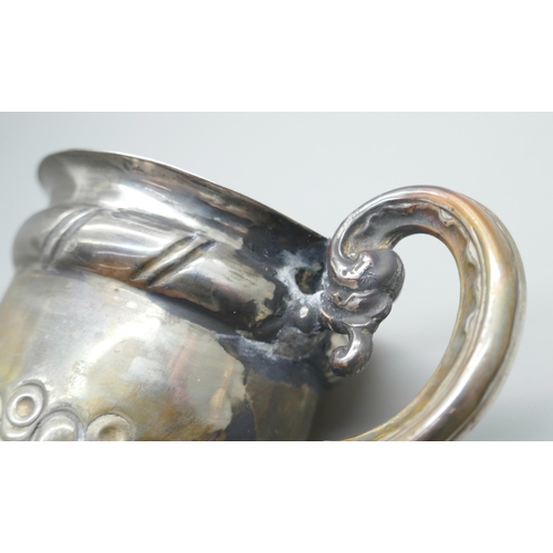 7232 - A small silver mug with embossed decoration, Birmingham 1904, a/f, 52g, 6.5cm