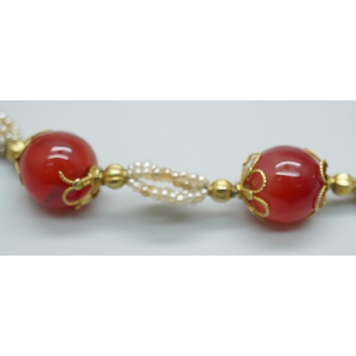 7237 - A carnelian and seed pearl necklace with gilt metal mounts, 40cm