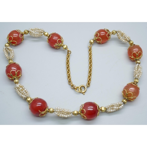 7237 - A carnelian and seed pearl necklace with gilt metal mounts, 40cm