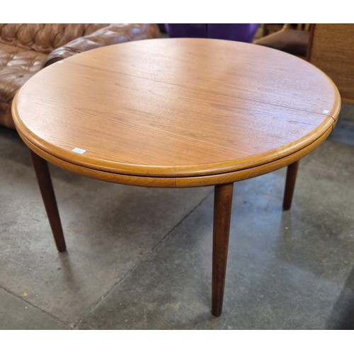 57 - A White & Newton teak circular extending dining table