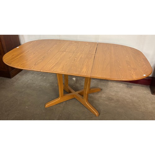 59 - An Ercol Blonde ash extending dining table