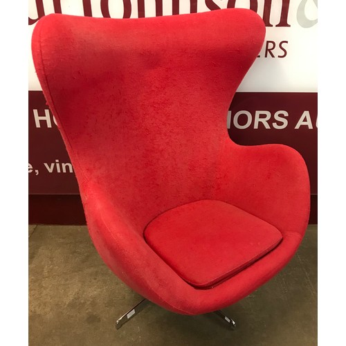 60 - An Arne Jacobsen style chrome red fabric upholstered egg chair