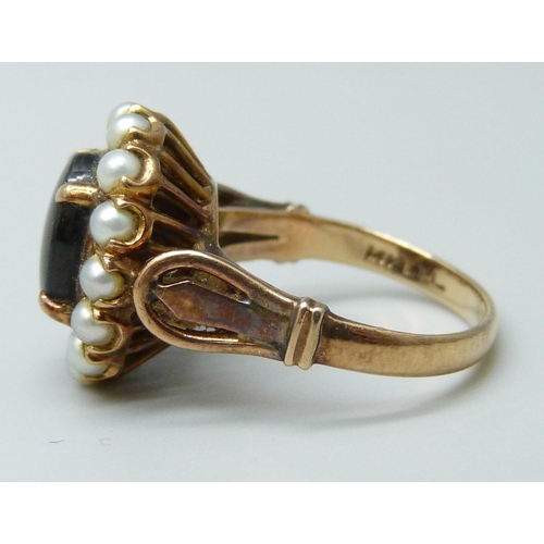 7002 - A 14k gold ring set with a brown star sapphire and pearls, 4.9g, J