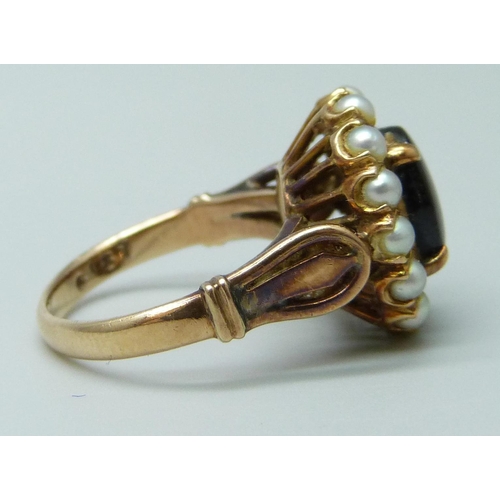 7002 - A 14k gold ring set with a brown star sapphire and pearls, 4.9g, J