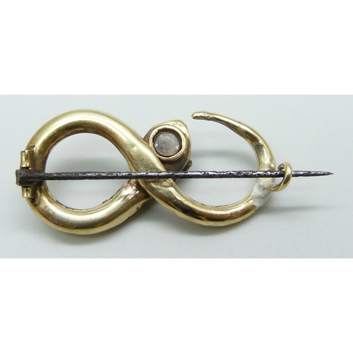 7017 - A late 19th Century yellow metal turquoise 
set brooch in the form of a snake, with memorial compart... 