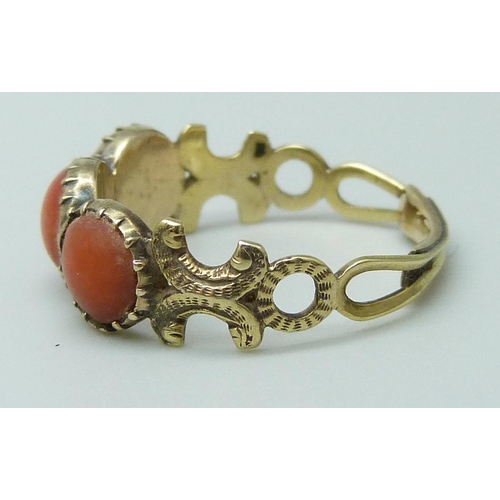 7020 - A 19th Century yellow metal and coral ring, 1.5g, J, and a pair of gilt earrings also set with coral